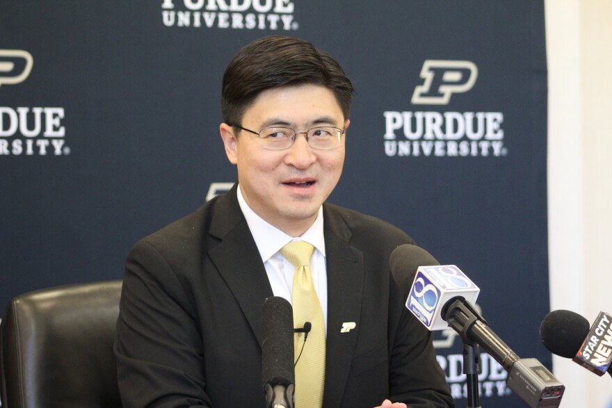 Purdue President Mung Chiang smiles at reporters. 