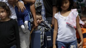 Immigrant families seeking asylum walk to a respite center after they were processed and released by U.S. Customs and Border Protection, Friday, June 29, 2018, in McAllen, Texas.