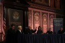 FILE - The archbishop of Miami, Thomas Wenski, raises his hand while addressing a crowd during a panel on immigration at Georgetown University in Washington, Thursday, Sept. 11, 2025.