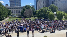 A few hundred protesters gather at the Indiana War Memorial after marching from the Indiana Statehouse. The demonstration is also working to register people to vote.