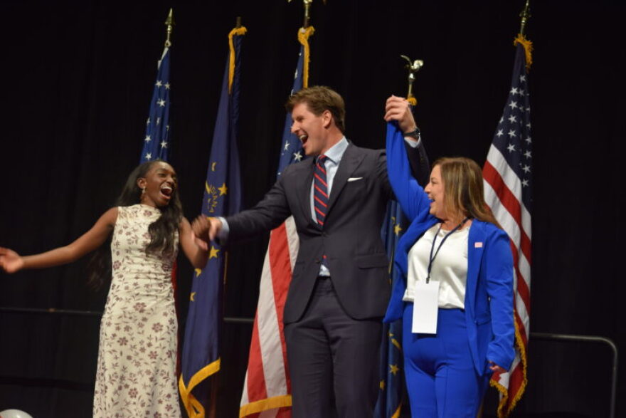 Beau Bayh celebrates after winning the Democratic secretary of state nomination at the Indiana Democratic Convention on June 6, 2026, in Indianapolis. The party also formally nominated Coumba Kebe, left, for state treasurer, and Jessica Bailey, right, for state comptroller.