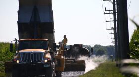 A Miami County highway crew chip-and-seals a road on July 30, 2026.