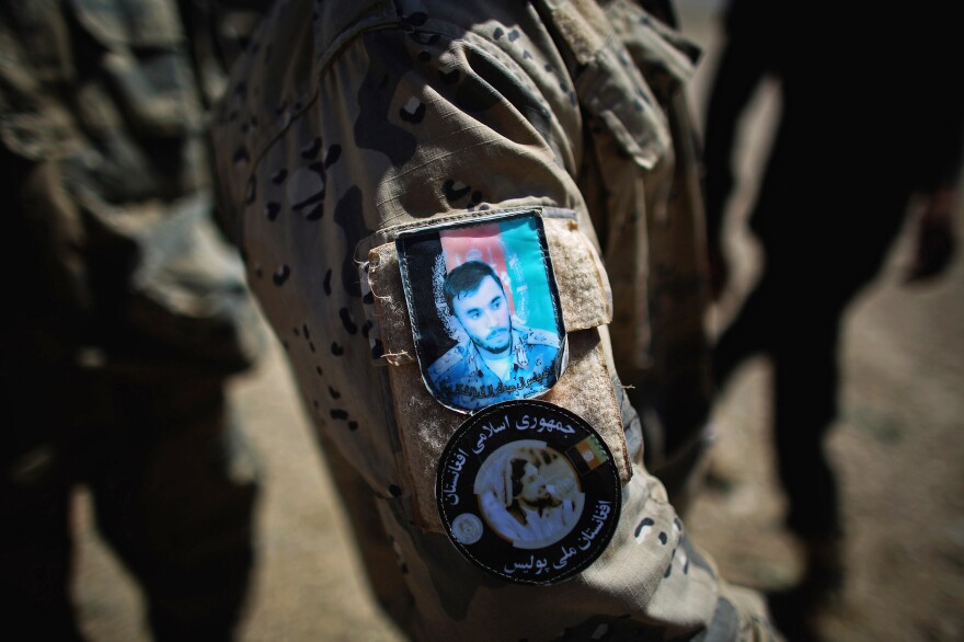 A patch on an Afghan National Police officer's uniform features the face of Raziq.