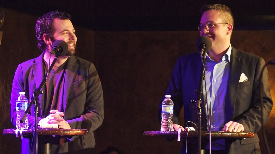 Joseph Fink (L) and Jeffrey Cranor, the creators of <em>Welcome to Night Vale, </em>on the<em> Ask Me Another</em> stage.