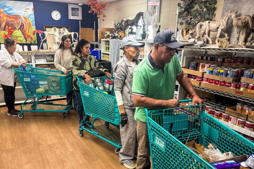 People pick up a food at the Community Ministry Food Pantry.