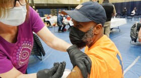 Michael Elliott receives the Johnson and Johnson COVID-19 vaccination from Barbara Scott, at St. Louis Community College at Forest Park in St. Louis on Thursday, March 25, 2021. The mass vaccination was able to put 3000 shots into arms in eight hours. 