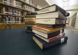 A stack of books in the John C. Pace Library on the Pensacola campus.