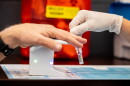 Pharmacy technician Bristelle McCullough, right, administers a BetterWay blood test to a patient at Lake Hills Pharmacy in August.