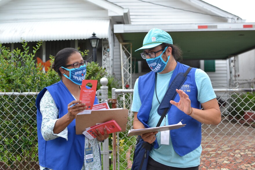  Together Louisiana volunteers Pestalozzy Montero de Quevedo (left) and Hugo Martinez (right) discuss their door-to-door knocking efforts in a New Orleans neighborhood, June 16, 2021.