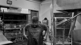 Zephaniah Cain puts his apron on in the early morning as he starts his day making bagels at Yorgo’s Bageldashery in Norfolk’s historic Ghent district.