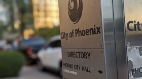A directory in downtown Phoenix points in the direction of Phoenix City Hall