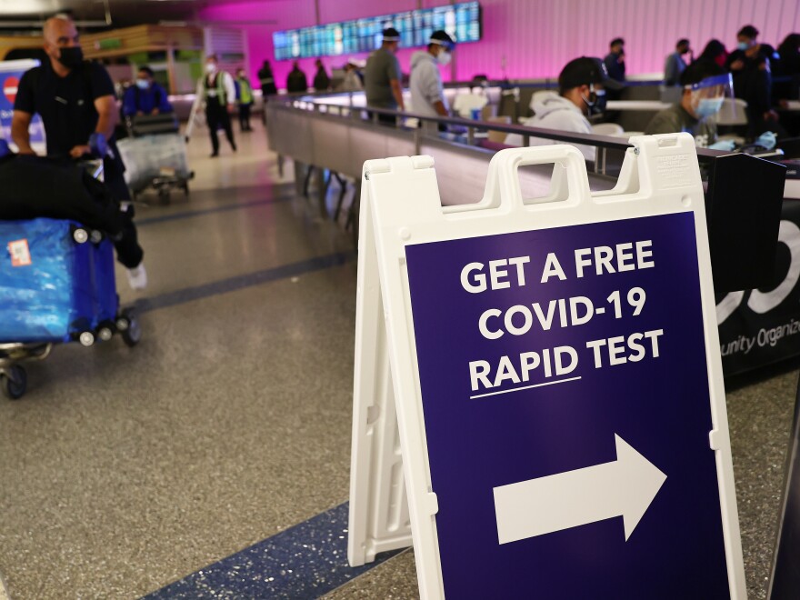 LOS ANGELES, CALIFORNIA - DECEMBER 03: An international passenger arrives near a new rapid COVID-19 testing site for arriving international passengers at Los Angeles International Airport (LAX) on December 3, 2021 in Los Angeles, California. The free voluntary tests are being offered to arriving passengers in the Tom Bradley International Terminal by the Los Angeles County Department of Health after the county confirmed its first case of the Omicron variant December 2. (Photo by Mario Tama/Getty Images)