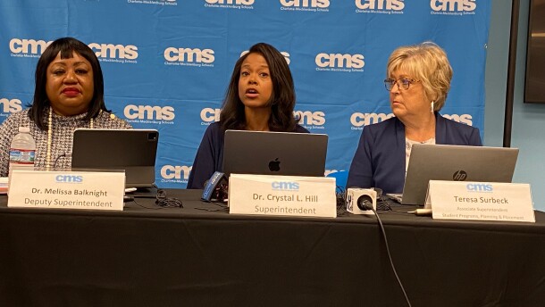 Superintendent Crystal Hill (center) addresses select reporters at an Aug. 12 briefing on her student assignment proposal.