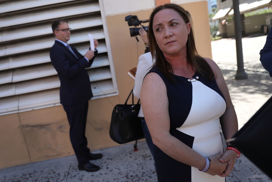 Lori Alhadeff and Ryan Petty, left, are seen in Fort Lauderdale, Fla., after turning in their paperwork to run for the Broward County School Board in May. Both parents had a 14-year-old daughter who was killed in the mass shooting at Marjory Stoneman Douglas High School in February.