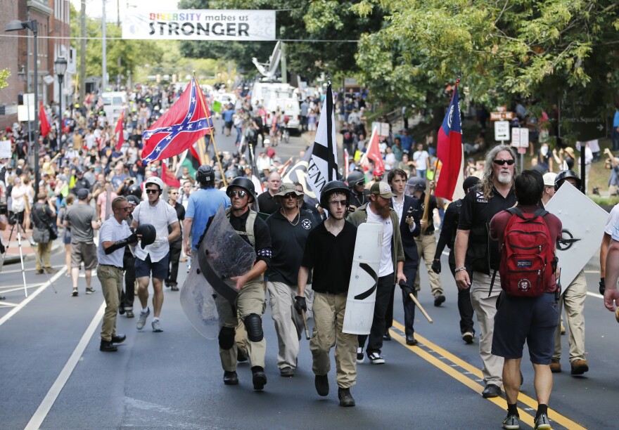 White nationalist demonstrators walk through Charlottesville on Aug. 12, 2017.