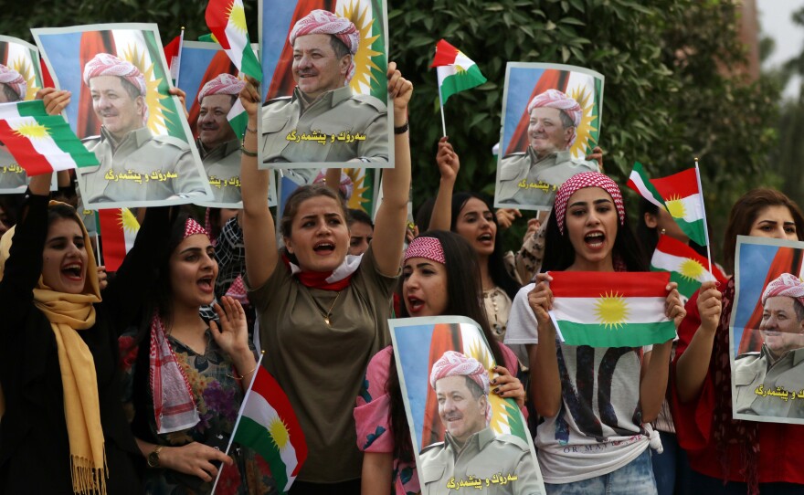Iraqi Kurdish students hold posters of Iraqi Kurdish leader Masoud Barzani during a demonstration in his support in Irbil, Iraqi Kurdistan, on Oct. 30.