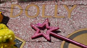 A wand with a star is placed over Dolly Parton's star on the Hollywood Walk of Fame Tuesday, Aug. 25, 2026, in Los Angeles. (Chris Pizzello/AP)