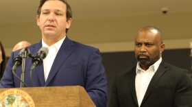 Ken Lawson, right, listens at a 2019 event with Gov. Ron DeSantis. (Courtesy of Governor's Press Office)
