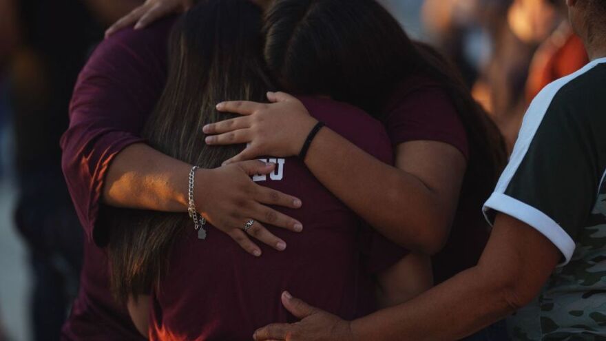 People mourn Wednesday as they attend a vigil for the victims of the mass shooting at Robb Elementary School in Uvalde, Texas.