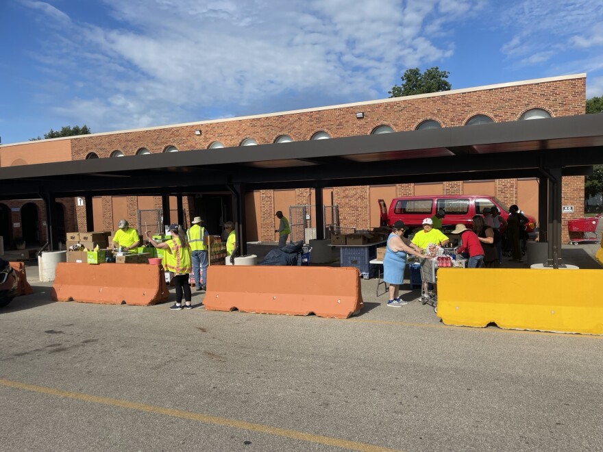 Volunteer staff assist clients at St. Vincent de Paul Food Pantry during food distribution.