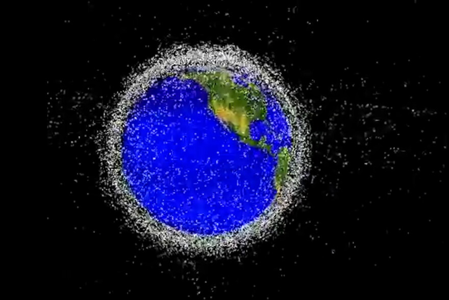 A NASA rendering shows satellites and space debris orbiting Earth.