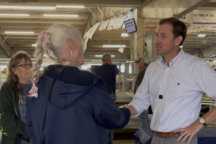 Michael Bridgford shakes a woman's hand. 