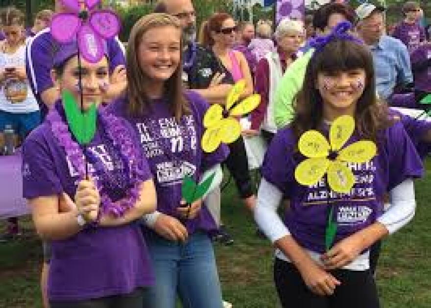 Young walkers show off the various colored "flowers" that signify participants' personal connection to the affliction.
