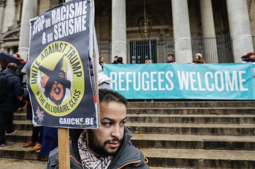 People protest against President Trump's executive immigration ban on Monday in Brussels, Belgium.