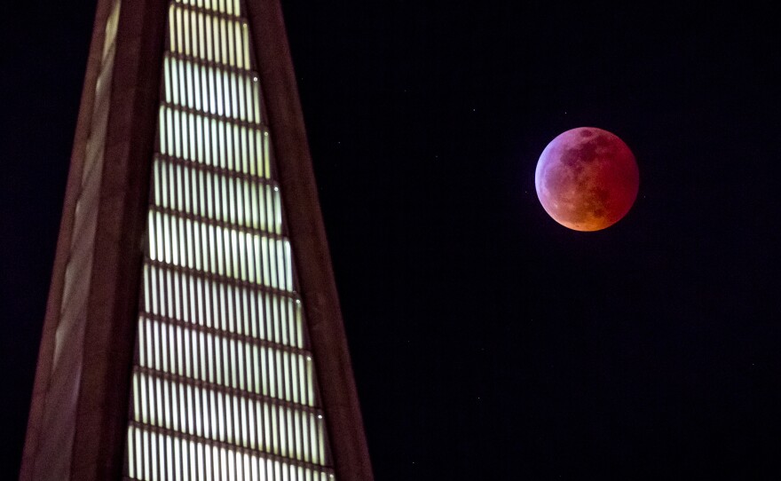 The "blood moon" rises behind the Transamerica pyramid in San Francisco on Sunday.
