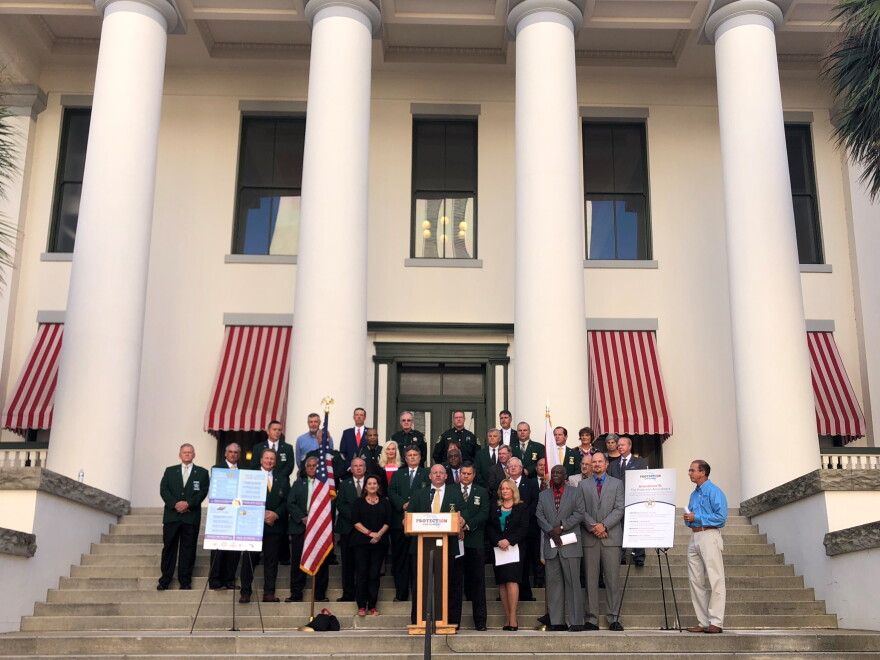 A coalition of local officials including Florida sheriffs, property appraisers, tax collectors and clerks of the circuit court gather outside the Capitol to support Amendment 10.