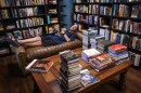 Underground Books owner D.S. Andersen demonstrates the comfort of the furniture in his Ogden shop’s reading room, July 17, 2026.