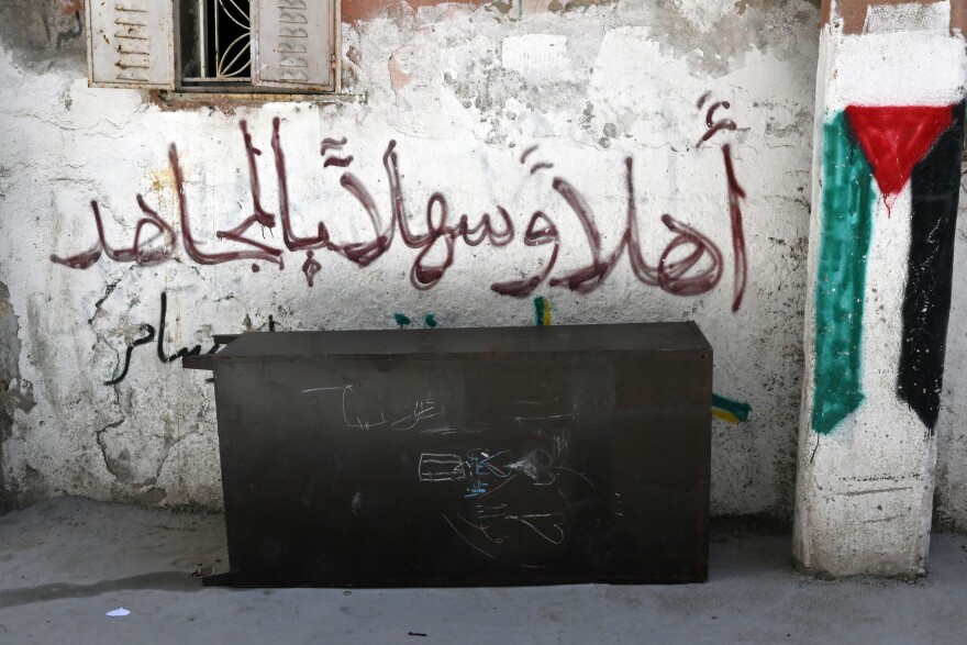 Graffiti of text that says "Welcome Resistance Fighter" and a Palestinian flag in Ramallah in the West Bank.