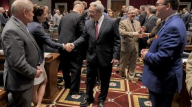 Chief Justice Paul Wilson, of the Missouri Supreme Court (center) shakes hands with lawmakers on Wednesday, Feb. 8, 2023, during the State of the Judiciary address at the State Capitol in Jefferson City.