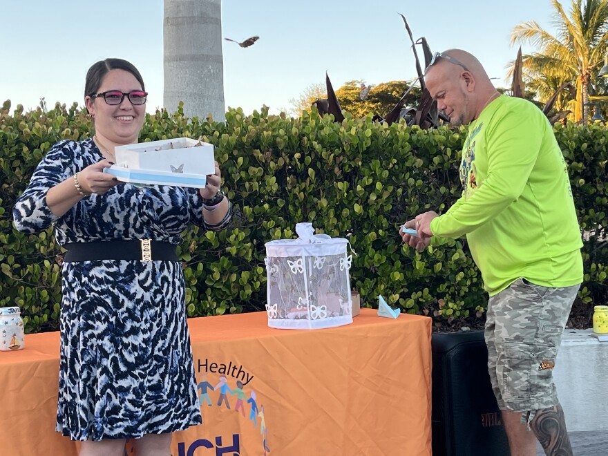 Holly Vingson-Ruiz (l.) and Paul DeMello (r.) release butterflies in Baker Park as part of the Twins Tot Vigil. Vingson-Ruiz's son drowned in 2018; DeMello's twin sons drowned in 2010.