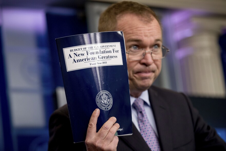 Budget Director Mick Mulvaney holds up a copy of President Trump's proposed fiscal 2018 federal budget at the White House on Tuesday.