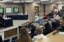 Peoria School Board 150 meeting March 23. The public looks across a horseshoe divider as committee members on a stage across the room deliberate.