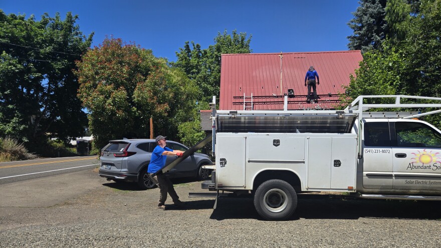 Crew members from Corvallis-based Abundant Solar install solar panels on a home in the community of Peoria, OR.