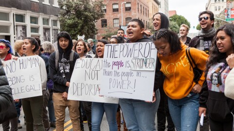 Protesters chant while holding various signs at a rally against Immigration and Customs Enforcement (ICE) in San Francisco.