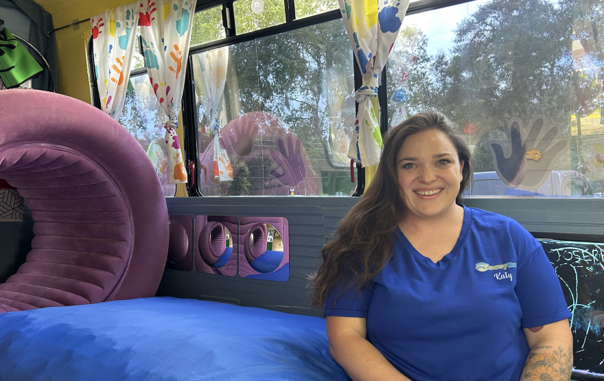 35-year-old Katy Alexander, the entrepreneur of The Sensory Bus, smiles sitting in her newest venture.