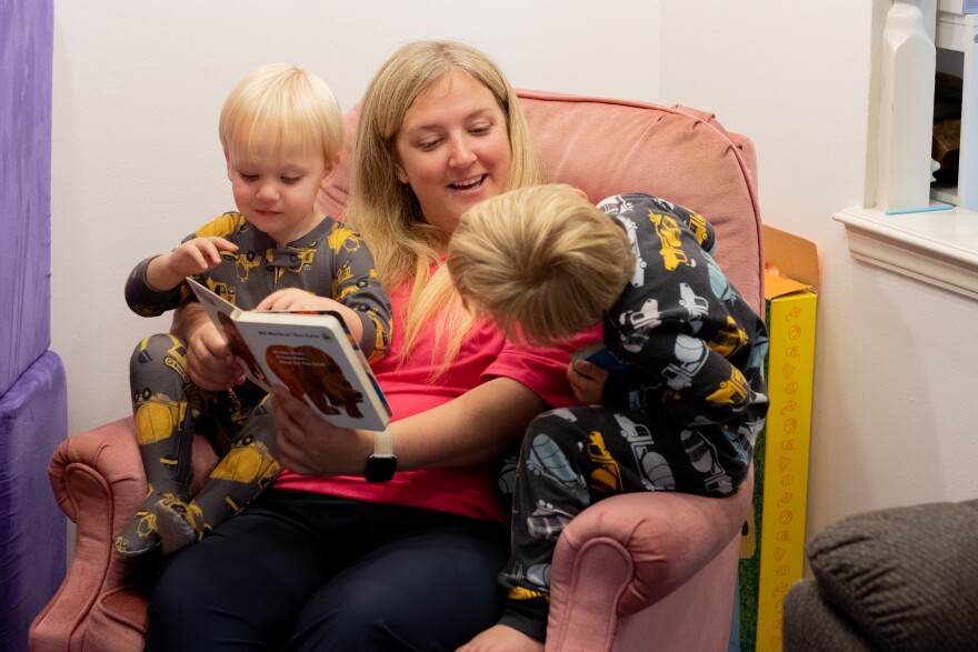 Jennifer Williams reads "Brown Bear, Brown Bear, What Do You See?" to her sons, Skyler (left) and SJ (right).