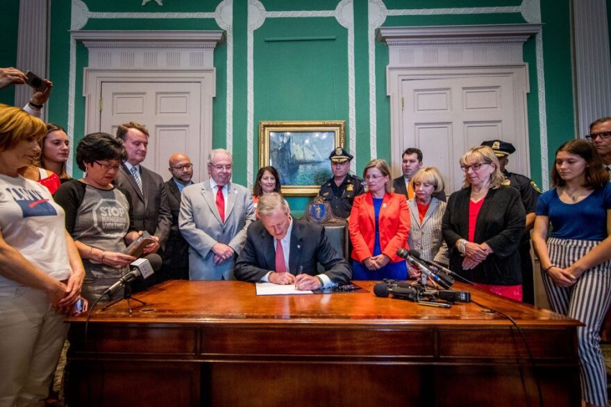 Gov. Charlie Baker signs the "red flag" bill into law on July 3, 2018. (Courtesy of the governor's office)