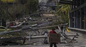 Downed power and telephone poles lay on a street after Hurricane Otis ripped through Acapulco, Mexico. (Felix Marquez/AP)