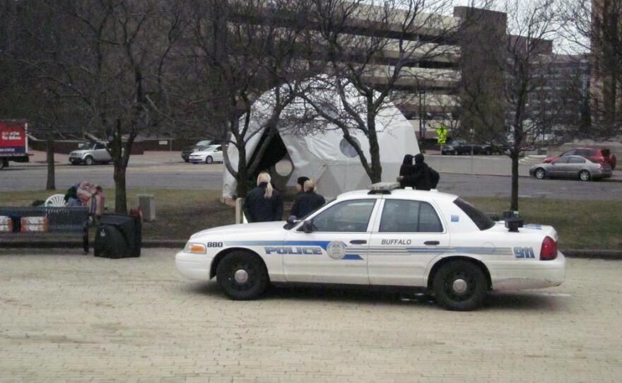 Buffalo Police officers watch as protestors remove two tents that Police allowed to remain overnight after the rest of the camp was evicted overnight. The protestors were to have the tents removed by mid-afternoon.