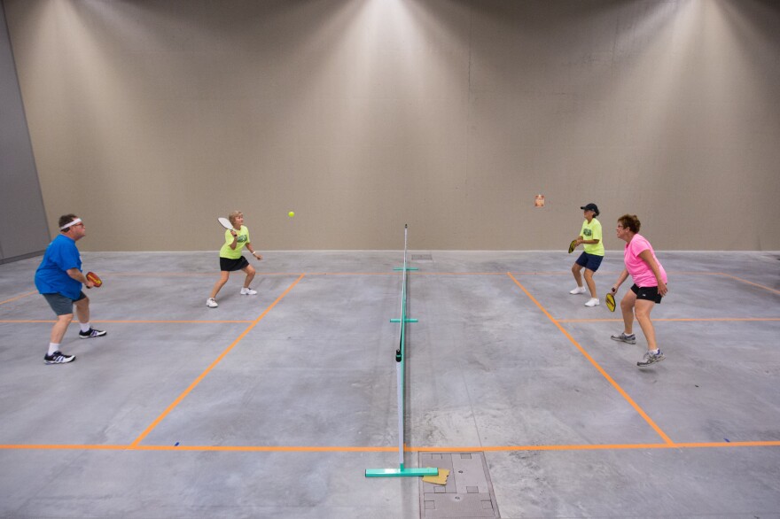 Mike Coats (left) and Rosemarie Pietromonaco return the ball to Beverly Miller and Diane Reynolds in a practice match of pickleball.