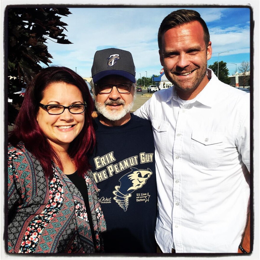Erik (right) poses with his father and sister.
