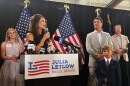 U.S. Rep. Julia Letlow, standing beside her fiancee Kevin Ainsworth, center right, and her son, addresses her supporters in Baton Rouge, La., Saturday, June 27, 2026, after winning the GOP Senate nomination. (AP Photo/Jack Brook)