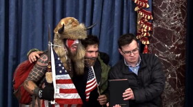 Richard Crosby, Jr. posing for a photo from the Senate Dais on January 6, 2021