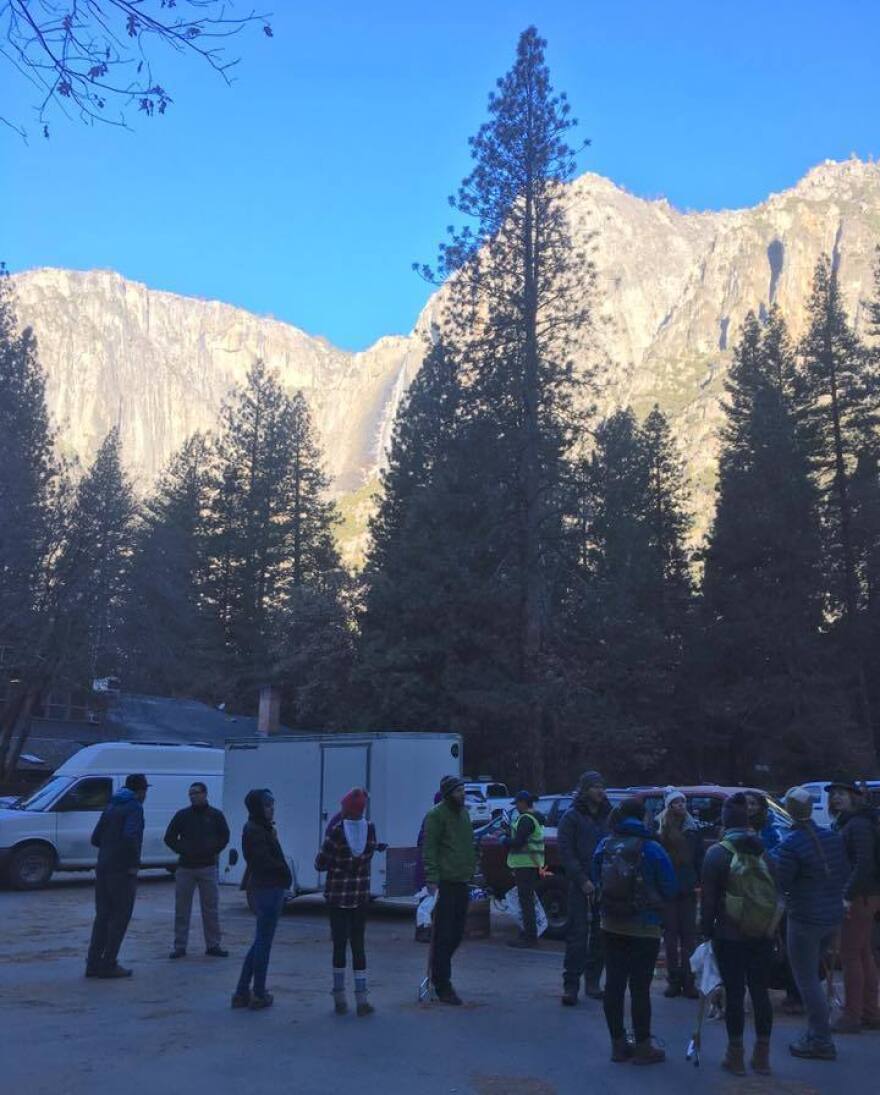 Volunteers pick up litter sticks and supplies in the shadow of Yosemite's Sierra Nevada Mountians.