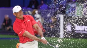 Tiger Woods of the Jupiter Links Golf Club plays a shot from a bunker on the eighth hole, during final day of TGL golf tournament, Tuesday, March 24, 2026, in Palm Beach Gardens Fla.
