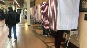 Voters mark their ballots in a long hallway
